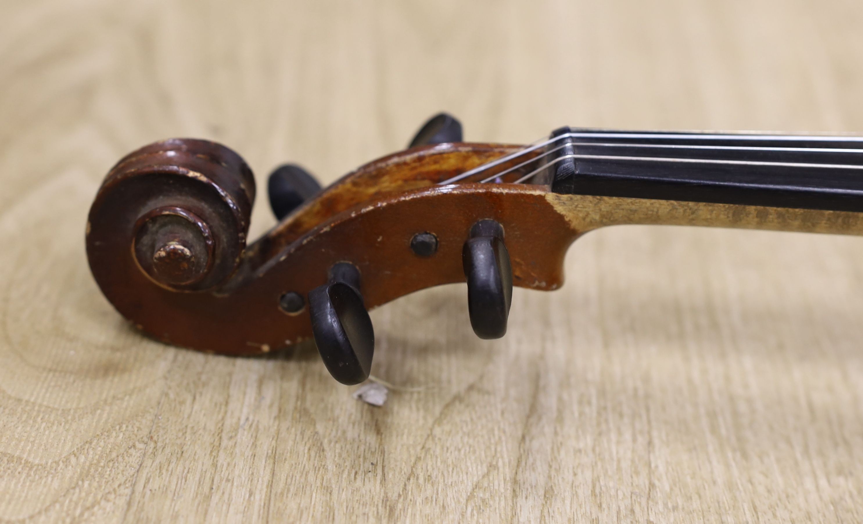 A cased violin, with bow